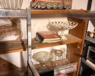 Vintage model trains, crystal glassware, and collectibles on shelves