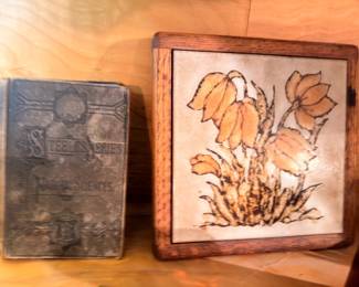 Antique leather-bound book and framed Art Nouveau floral print