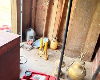 Red hydraulic floor jack and brass items