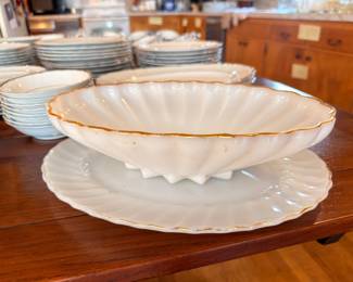 White china with gold trim, shell serving dish and plates