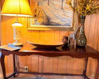 Antique mahogany console table with lamp and framed art