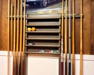 Pool cue rack with billiard cues and balls