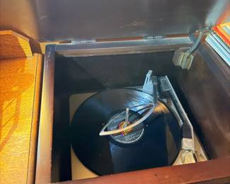 Vintage phonograph record player in wood cabinet
