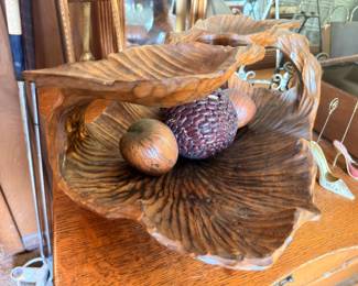 Carved wooden fruit in decorative shell bowl