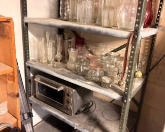 Metal shelving with glass jars, bottles, kitchen items