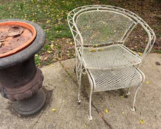 Cast iron chiminea outdoor fireplace, terra cotta planter, patio chair