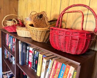 Woven baskets, red painted baskets, books on shelf