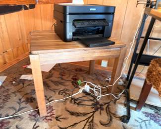 Printer on wooden side table, oriental area rug