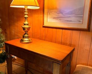 Oak end table with brass lamp and framed landscape print