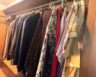 Men's shirts, plaid flannels, jackets on hangers
