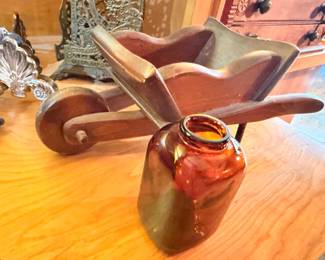 Carved wood folk art figure and amber glass jar