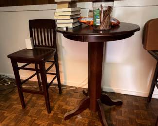 Dark wood round pub-height table with chair