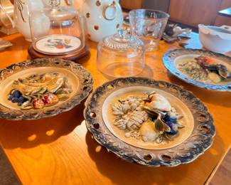 Hand-painted decorative ceramic plates and figurines, bird motifs