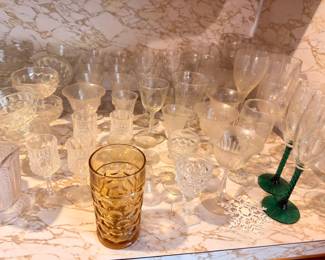 Vintage stemware, amber glasses, and green glass candlesticks