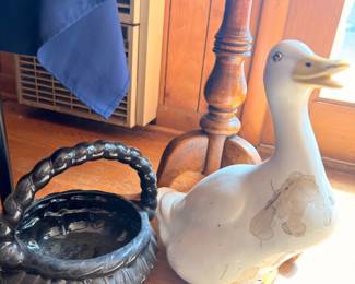 White ceramic duck figurine and metal basket