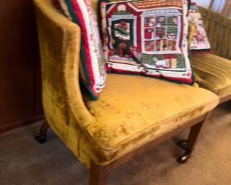 Vintage gold velvet upholstered chair with Christmas needlepoint pillow