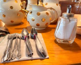 Silverplate flatware set, polka dot teapot, and glass sugar shaker