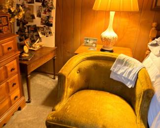 White ceramic table lamp with shade, green upholstered chair