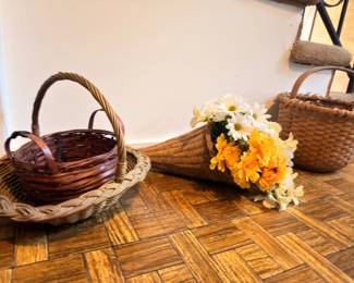Wicker baskets and artificial flower arrangement
