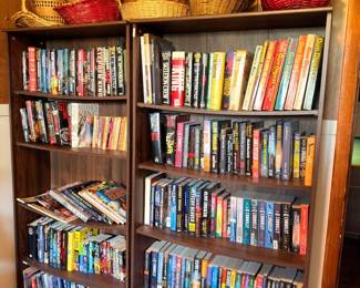 Bookshelf full of books, woven baskets on top