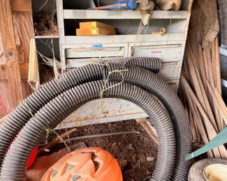 Shop vac, corrugated hose, and garage storage shelving