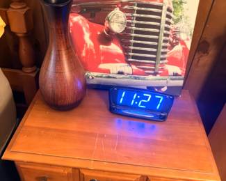 Oak nightstand, digital clock, wooden vase, vintage truck print