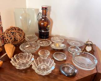 Clear glass dishes, amber bottle, small clock, wicker ball
