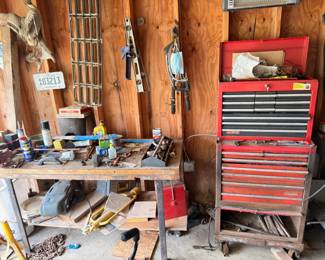Red rolling tool chest, hand tools, and workshop supplies