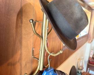 Vintage fedora hat on brass hat stand