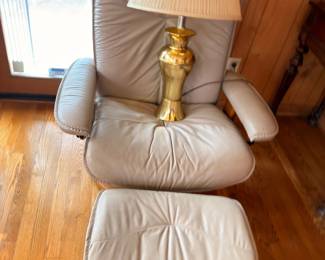 Leather recliner chair with ottoman and brass table lamp