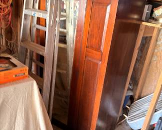 Antique wood furniture pieces in storage, cabinet and more