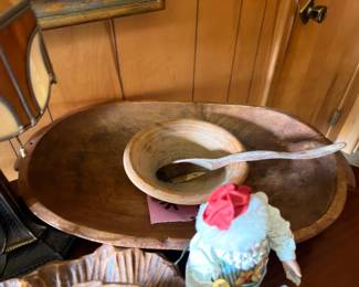 Antique wooden dough bowl with decorative figurine
