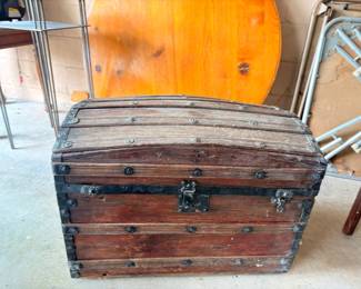 Antique dome-top steamer trunk with metal banding