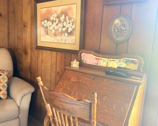 Antique oak secretary desk with framed artwork
