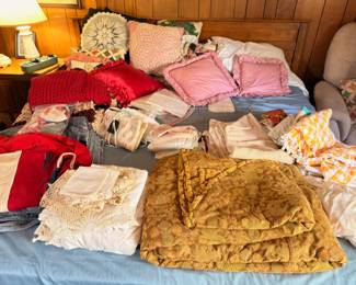 Assorted vintage quilts, blankets, and linens