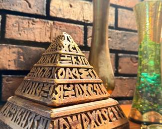 Carved Egyptian pyramid sculpture with hieroglyphics