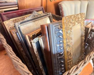 Assorted framed artwork and picture frames