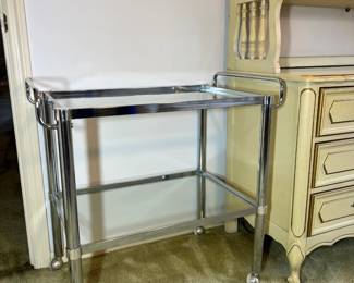 Metal and glass bar cart on wheels