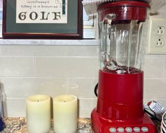 Red KitchenAid blender with a glass jar