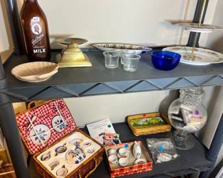 Miniature Porcelain & Glass – A set of blue and white miniature tea sets in a wicker picnic basket, shown with vintage Borden’s milk bottles and cobalt blue glassware