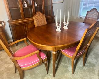 Formal Dining Set: Oval wood dining table with leaf and set of cane-back chairs with pink upholstered seats