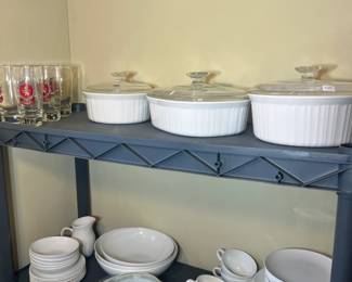Vintage CorningWare "French White" round and oval casserole dishes with glass lids, and a white ceramic dinnerware set