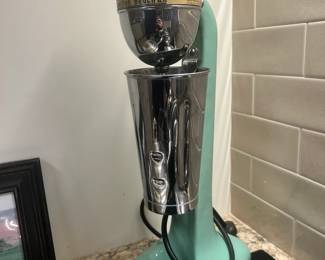 A vintage seafoam green Hamilton Beach No. 33 milkshake mixer (missing a foot)
