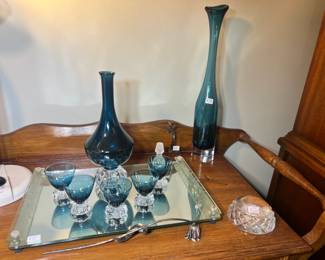 Stunning teal-blue glassware set including a tall tapered vase, a bulbous decanter, and matching stemmed cordial glassester and glasses