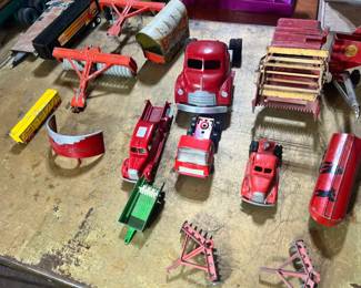 A collection of vintage red tractors, harvesters, and a Gulf Oil tanker, featuring Massey-Harris and Gulf branding