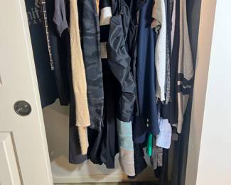 A packed closet featuring a wide variety of styles, including camo-print hoodies, designer blazers, and high-quality knits