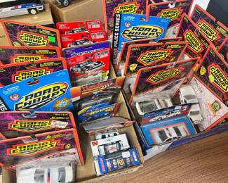A massive collection of vintage 1:43 scale die-cast metal Road Champs Police Series vehicles, including various state and local patrol liveries, many still in their original 1990s packaging