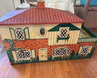 Vintage children’s tin house with original toys inside
