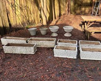 Many outdoor vintage cement planters 