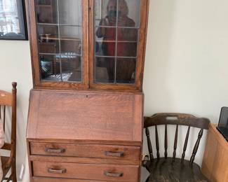 #126	Wood Secretary w/2 leaded glass doors w/2 shelves & 3 drawers w/flip-front and cubbies - 28x15-27x72" tall (as is side crack and trim on bottom)	 $100.00 